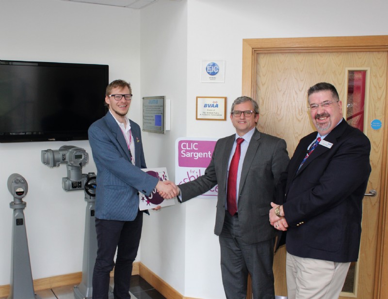 CLIC Sargents James McDonald (left) receiving the donation from Auma UKs MD Paul Hopkins with BVAAs Rob Bartlett